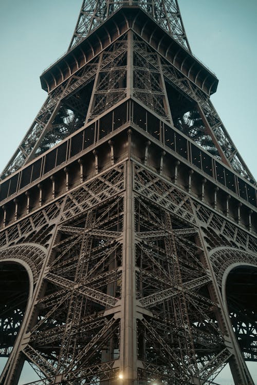Close-up of the intricate wrought iron lattice structure of the Eiffel Tower showing detailed engineering design.