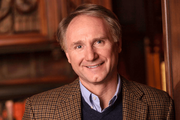 Dan Brown in professional setting with books