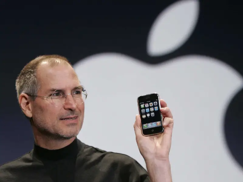 Apple's first iPhone in Steve Jobs's hands.