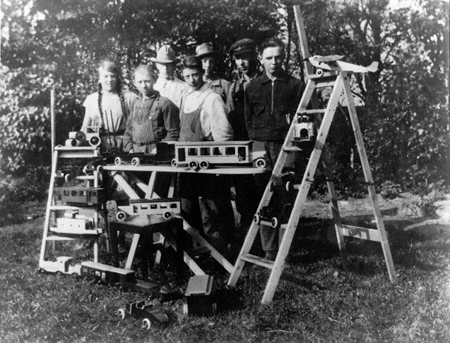 Early wooden toy vehicles crafted by LEGO founder's workshop in a historical photo from the beginning of the LEGO Group.
